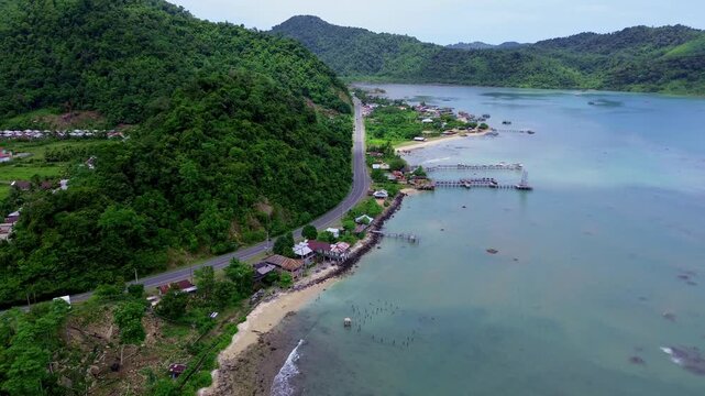 Tropical Highway Between Lush Hills and the Ocean on the Coast