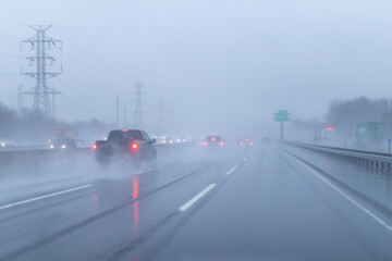 Car driving in rain on road