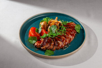 Sliced glazed duck breast served with grilled mushrooms, fresh tomatoes, cilantro and green onions...