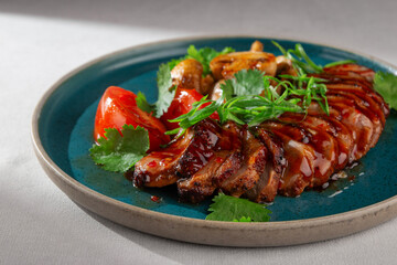 Sliced glazed duck breast served with grilled mushrooms, fresh tomatoes, cilantro and green onions...