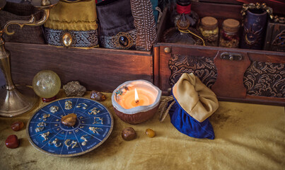 Enchanted ritual altar with burning candle, mystical hand, and ancient grimoire on golden cloth
