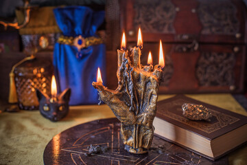 Enchanted ritual altar with burning candle, mystical hand, and ancient grimoire on golden cloth