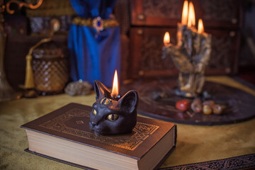 Enchanted ritual altar with burning candle, mystical hand, and ancient grimoire on golden cloth