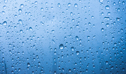 Closeup of Water Droplets on a Light Blue Surface