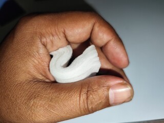 hand holding a tissue