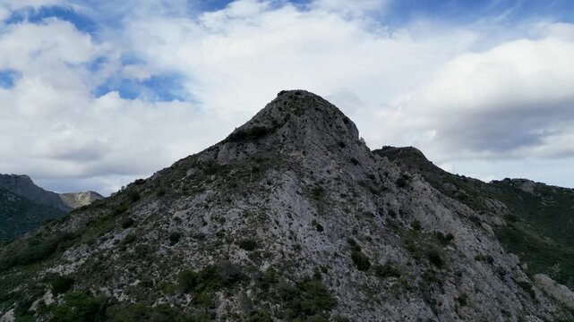 Aerial view of rugged mountains against a backdrop of a cloudy sky, showcasing the natural beauty, Ojen, Marbella, Spain.