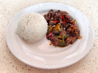 Black Pepper Beef with Steamed Rice on White Plate