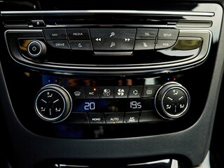 Car radio with buttons for music, climate control, and other features