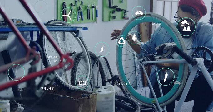 Mechanic rotating turquoise wheel and tuning spokes while monitoring floating data icons