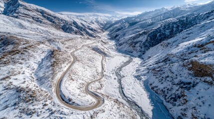 Winding road through snowy mountain valley