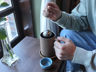Man drinking tea in cafe, closeup. vintage mood