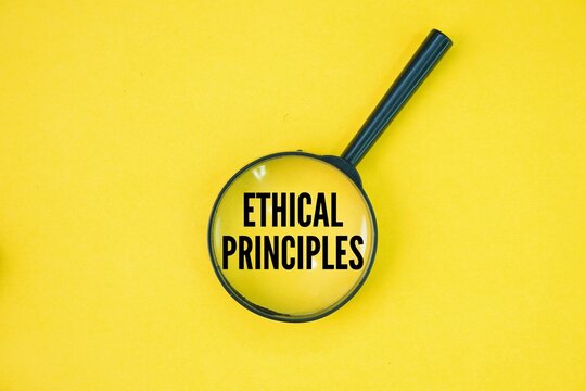 A magnifying glass with the word ethical principles. fundamental guidelines for determining right and wrong conduct. Some core ethical principles include honesty, fairness, respect, responsibility