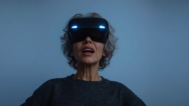 An elderly woman wearing virtual reality glasses, immersed in a digital world, demonstrates the combination of technology and age, highlighting how virtual reality can engage and entertain people - Powered by Adobe