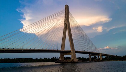 Obraz premium Stunning cable-stayed bridge at sunset over a waterway