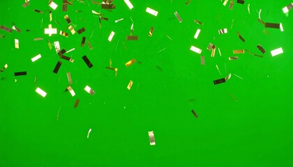 Gold confetti falling against green background