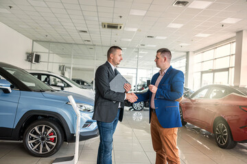 shaking hands with two man salesman and client after success deal selling or rental car