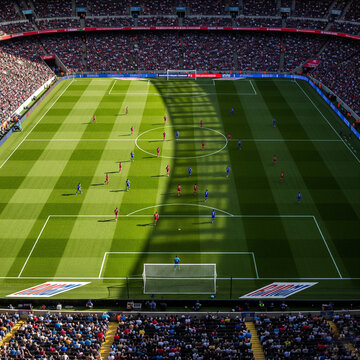 Soccer field with a crowd of people watching the game