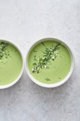 Two bowls of healthy detox soup on clean background with lots of copy space. 