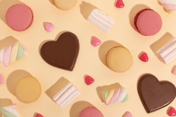 seamless background with chocolate and marshmallows, macaroons, and sweets on a pastel  background