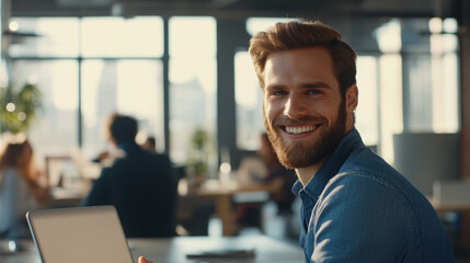 Smiling Young Professional Working on Laptop in a Cozy Cafe