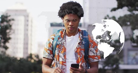 Male traveler tapping smartphone screen and revealing transparent world map overlay and laughing - Powered by Adobe