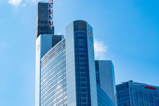 Commerzbank building, Modern glass skyscrapers rise against blue sky, Contemporary urban area, European city district, Corporate Finance and Business, headquartered Frankfurt, Germany