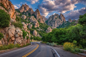 Fototapeta premium Winding road through rocky mountain pass at sunset