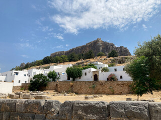 Lindos, Rhodes, Greece - 13 August, 2022: Typical Greek island whitewashed houses in Lindos with...