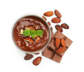 Delicious panna cotta with almonds, cocoa beans and chocolate pieces isolated on white, top view
