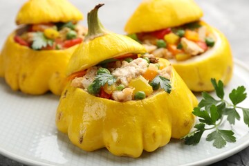Tasty stuffed pattypan squashes on grey table, closeup