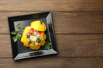 Tasty stuffed pattypan squash on wooden table, top view. Space for text