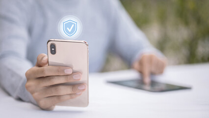 Hand Holding Smartphone With Virtual Security Shield Icon