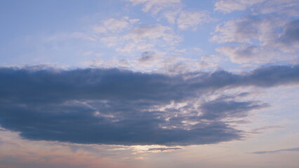 Experience the breathtaking beauty of a sunset amidst a dramatic and captivating cloudscape