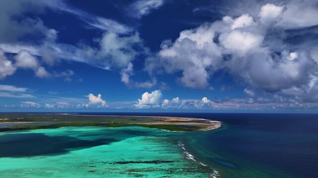 Aerial view of the mesmerizing turquoise waters meeting the dark blue sea, where vibrant coral reefs lie beneath the surface, Bonaire, Bonaire, Caribbean Netherlands.