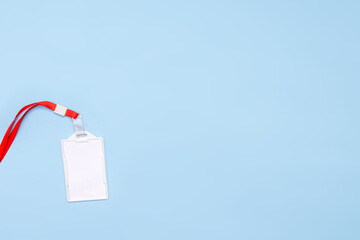 Blank ID Card With Red Lanyard On Light Blue Background