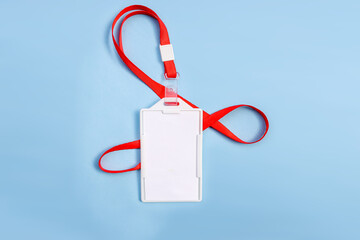 Blank White ID Card Holder With A Red Lanyard Isolated On Blue Background
