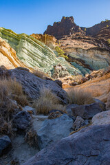 Gran Canaria, Canary Islands, Spain: view of Los Azulejos De Veneguera (Rainbow Rocks), a real geology open air museum along the scenic road from La Aldea de San Nicolas to Mogan. Mountain, erosion