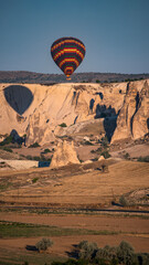 Cappadocia, Turkey, Europe: traditional hot air balloons floating after dawn in the sky over the valley of Cavusin in the region in Central Anatolia rich of exceptional natural wonders