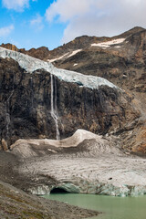 Lombardy, Italy, Europe: view of the Fellaria glacier in Valmalenco, Sondrio: ice cliff, rock face with waterfalls and lake. Marson glaciological trail. Climate change, melting glaciers