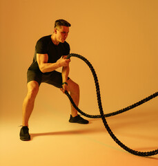 Athletic man with fit muscular body training in studio, concept about sport, functional workout and healthy lifestyle