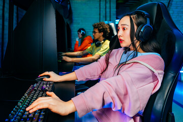 Multiethnic group of young friends playing videogames