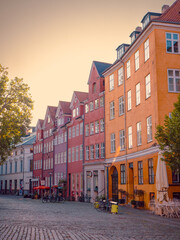 Fototapeta premium Colorful buildings surround cobblestone Gråbrødretorv square in central Copenhagen, Denmark, on a sunny summer day.