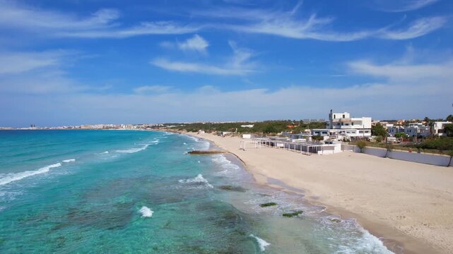 Baia Verde, Gallipoli - Apulia, Italy - Action aerial shot over the sandy beach with sea surf