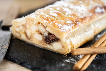 Homemade apple strudel on wooden table