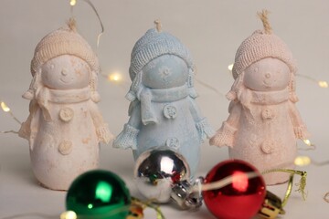 Three Decorative Snowmen with Christmas Balls and Garland Background — Festive Winter Scene for Cards, Advertising, and Interior Styling
