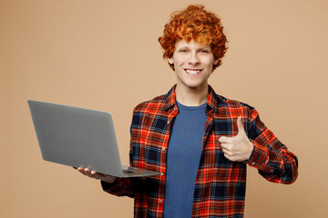 Young redhead IT man he wear red shirt blue t-shirt casual clothes hold use work on laptop pc...
