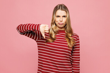 Young sad mad woman she wearing red striped sweatshirt casual clothes showing thumb down dislike...