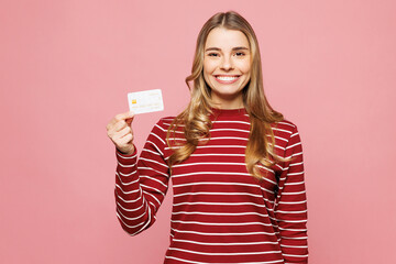 Young smiling happy woman she wearing red striped sweatshirt casual clothes hold in hand mock up of...