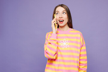 Young woman wears yellow sweatshirt casual clothes talk speak on mobile cell phone conducting...