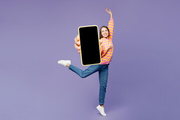 Full body young woman she wearing yellow sweatshirt casual clothes hold in hand use mobile cell...